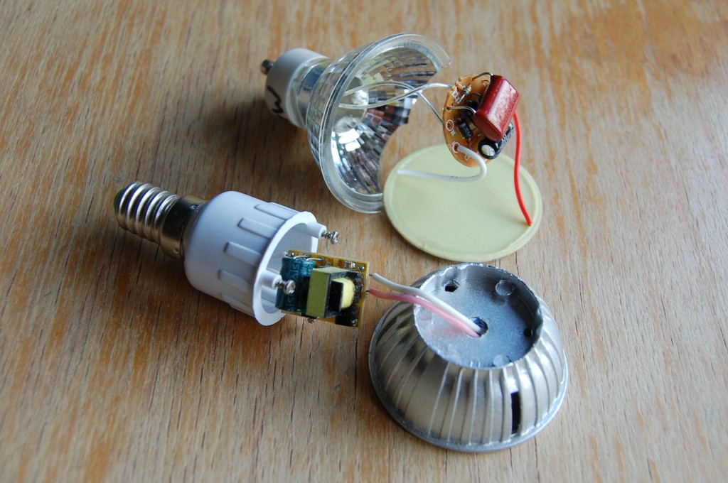 Front: EMI dirty LED bulb with unfiltered buck converter, recognisable by its yellow transoformer; Back: EMI clean LED bulb with a big, red‑coloured series high‑voltage capacitor.